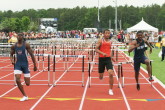 Darren McCluskey finishes the hurdles in Finals